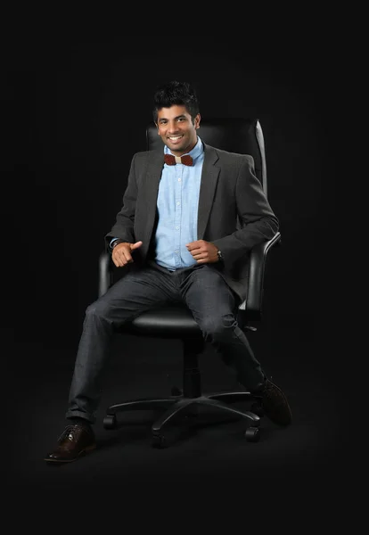 Portrait Young Businessman Sitting Chair Looking Camera Isolated Black Background —  Fotos de Stock