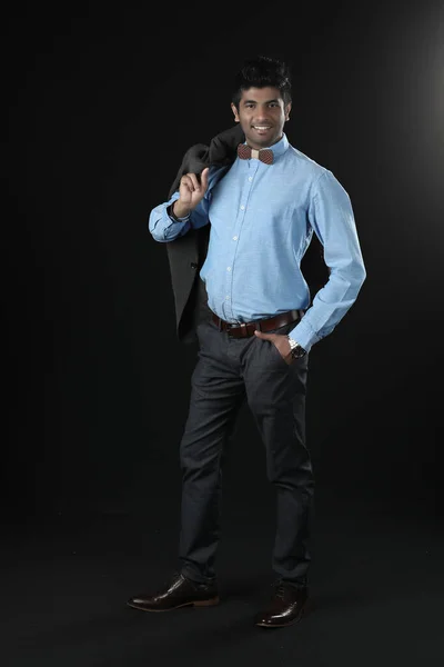 Portrait shot of indian  smart businessman model take formal suit jacket uniform off hold on arm standing lean on chair