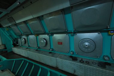 Cruise ship engine room interior with water tight doors electrical and diesel engines, water pipes, measuring instruments, diesel engines