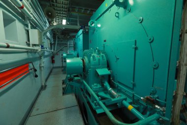 Cruise ship engine room interior with water tight doors electrical and diesel engines, water pipes, measuring instruments, diesel engines