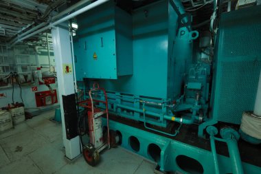 Cruise ship engine room interior with water tight doors electrical and diesel engines, water pipes, measuring instruments, diesel engines