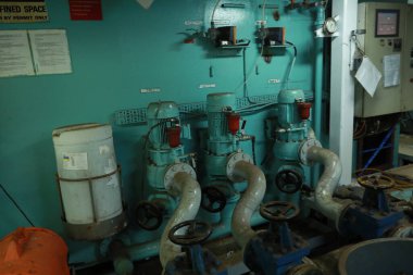 Cruise ship engine room interior with water tight doors electrical and diesel engines, water pipes, measuring instruments, diesel engines