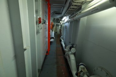 Cruise ship engine room interior with water tight doors electrical and diesel engines, water pipes, measuring instruments, diesel engines