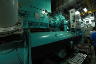 Cruise ship engine room interior with water tight doors electrical and diesel engines, water pipes, measuring instruments, diesel engines