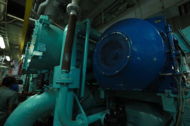 Cruise ship engine room interior with water tight doors electrical and diesel engines, water pipes, measuring instruments, diesel engines