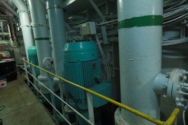 Cruise ship engine room interior with water tight doors electrical and diesel engines, water pipes, measuring instruments, diesel engines