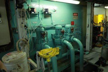 Cruise ship engine room interior with water tight doors electrical and diesel engines, water pipes, measuring instruments, diesel engines