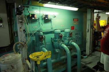 Cruise ship engine room interior with water tight doors electrical and diesel engines, water pipes, measuring instruments, diesel engines