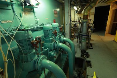 Cruise ship engine room interior with water tight doors electrical and diesel engines, water pipes, measuring instruments, diesel engines