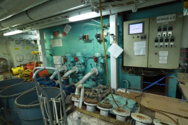 Cruise ship engine room interior with water tight doors electrical and diesel engines, water pipes, measuring instruments, diesel engines