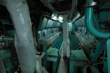 Cruise ship engine room interior with water tight doors electrical and diesel engines, water pipes, measuring instruments, diesel engines