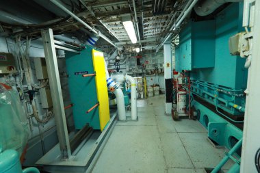 Cruise ship engine room interior with water tight doors electrical and diesel engines, water pipes, measuring instruments, diesel engines