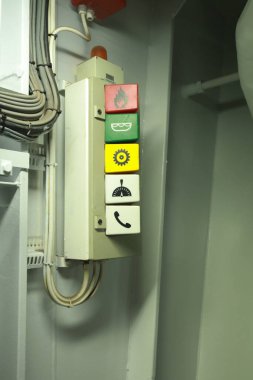 Cruise ship engine room interior with water tight doors electrical and diesel engines, water pipes, measuring instruments, warning signs