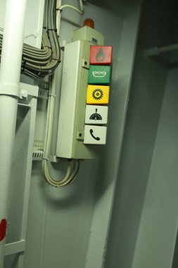 Cruise ship engine room interior with water tight doors electrical and diesel engines, water pipes, measuring instruments, warning signs