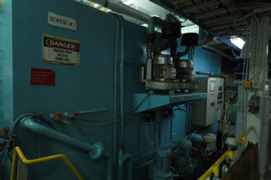 Cruise ship engine room interior with water tight doors electrical and diesel engines, water pipes, measuring instruments, diesel engines