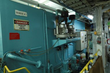 Cruise ship engine room interior with water tight doors electrical and diesel engines, water pipes, measuring instruments, diesel engines