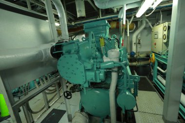 Cruise ship engine room interior with water tight doors electrical and diesel engines, water pipes, measuring instruments, diesel engines