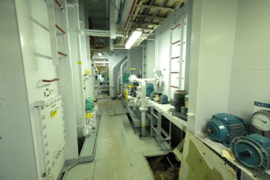 Cruise ship engine room interior with water tight doors electrical and diesel engines, water pipes, measuring instruments, diesel engines