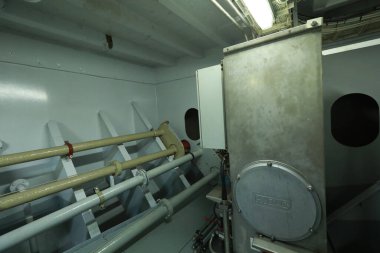 Cruise ship engine room interior with water tight doors electrical and diesel engines, water pipes, measuring instruments, diesel engines