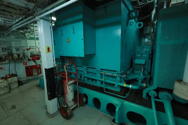 Cruise ship engine room interior with water tight doors electrical and diesel engines, water pipes, measuring instruments, diesel engines