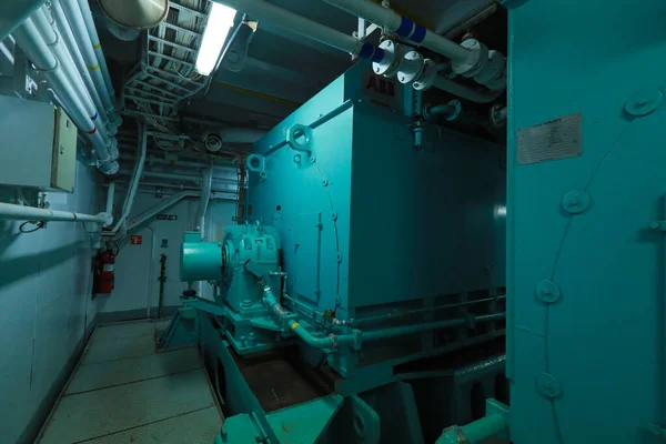 Cruise ship engine room interior with water tight doors electrical and diesel engines, water pipes, measuring instruments, diesel engines