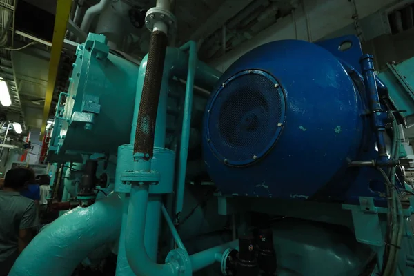Cruise ship engine room interior with water tight doors electrical and diesel engines, water pipes, measuring instruments, diesel engines