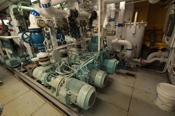 Cruise ship engine room interior with water tight doors electrical and diesel engines, water pipes, measuring instruments, diesel engines