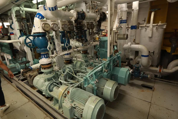 Cruise ship engine room interior with water tight doors electrical and diesel engines, water pipes, measuring instruments, diesel engines