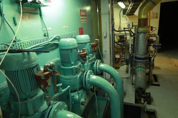 Cruise ship engine room interior with water tight doors electrical and diesel engines, water pipes, measuring instruments, diesel engines