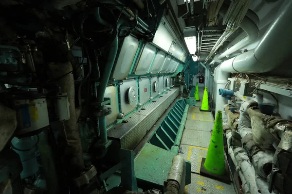 Cruise ship engine room interior with water tight doors electrical and diesel engines, water pipes, measuring instruments, diesel engines