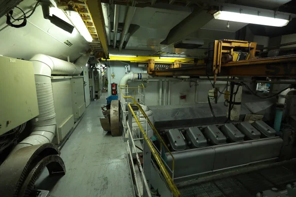 Cruise ship engine room interior with water tight doors electrical and diesel engines, water pipes, measuring instruments, diesel engines