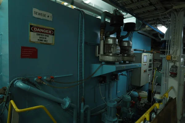 Cruise ship engine room interior with water tight doors electrical and diesel engines, water pipes, measuring instruments, diesel engines