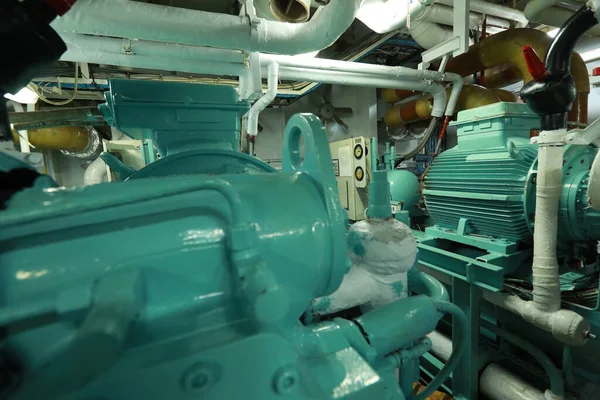Cruise ship engine room interior with water tight doors electrical and diesel engines, water pipes, measuring instruments, diesel engines