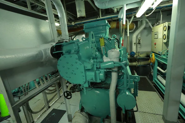 Cruise ship engine room interior with water tight doors electrical and diesel engines, water pipes, measuring instruments, diesel engines