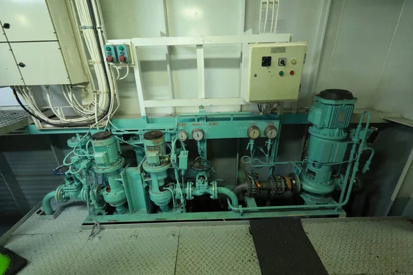 Cruise ship engine room interior with water tight doors electrical and diesel engines, water pipes, measuring instruments, diesel engines