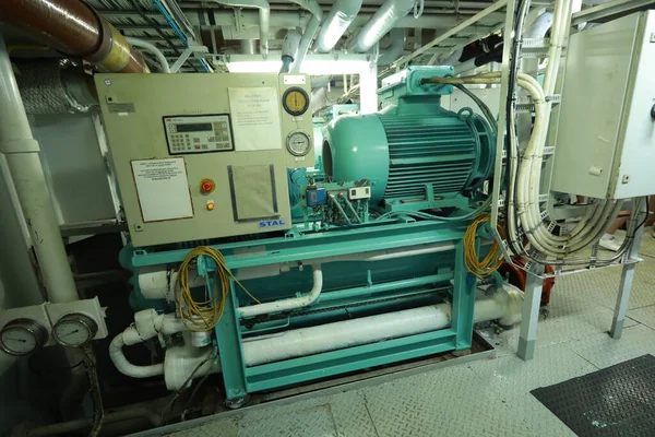 Cruise ship engine room interior with water tight doors electrical and diesel engines, water pipes, measuring instruments, diesel engines