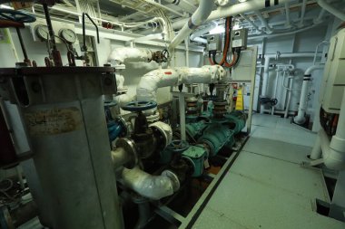 Cruise ship engine room interior with water tight doors electrical and diesel engines, water pipes, measuring instruments, diesel engines