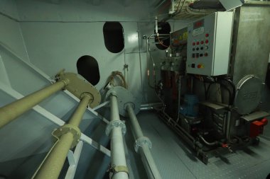 Cruise ship engine room interior with water tight doors electrical and diesel engines, water pipes, measuring instruments, diesel engines