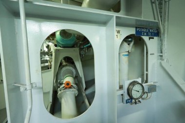 Cruise ship engine room interior with water tight doors electrical and diesel engines, water pipes, measuring instruments, diesel engines
