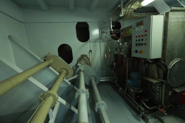 Cruise ship engine room interior with water tight doors electrical and diesel engines, water pipes, measuring instruments, diesel engines