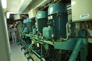 Cruise ship engine room interior with water tight doors electrical and diesel engines, water pipes, measuring instruments, diesel engines