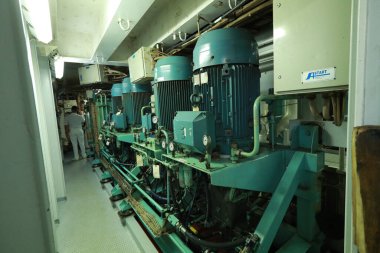 Cruise ship engine room interior with water tight doors electrical and diesel engines, water pipes, measuring instruments, diesel engines