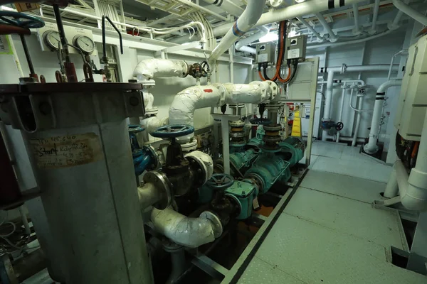 Cruise ship engine room interior with water tight doors electrical and diesel engines, water pipes, measuring instruments, diesel engines