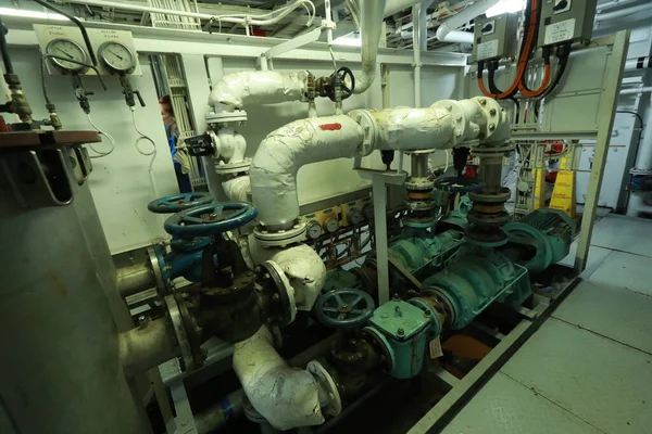 Cruise ship engine room interior with water tight doors electrical and diesel engines, water pipes, measuring instruments, diesel engines