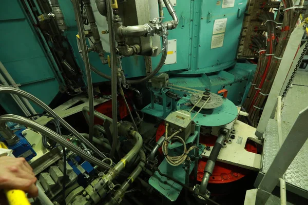 Cruise ship engine room interior with water tight doors electrical and diesel engines, water pipes, measuring instruments, diesel engines