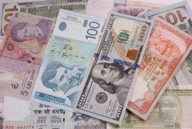 Flat lay or top view of world international banknotes vary countries background. US Dollar, Chinese yuan, Japanese yen, Euro, Indian rupee, Thai baht. Concept of Forex or global financial economic.