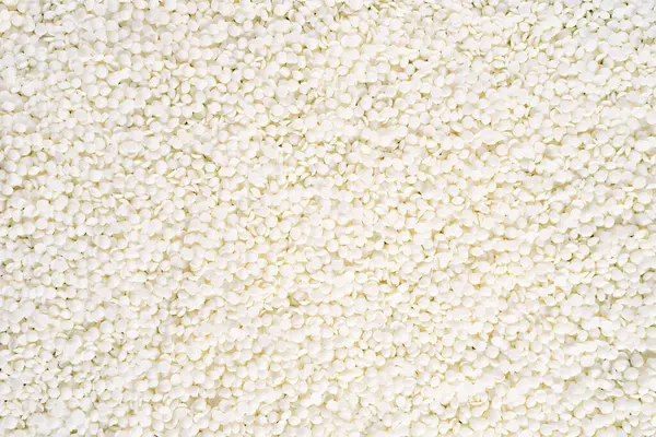 Full frame of soy wax flakes for candle making. Organic soy wax background for design, text. Top view. copy space. Flat lay