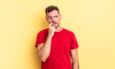 Şaşırmış, gergin, endişeli ya da korkmuş bakışları olan genç, yakışıklı İspanyol adam fotokopi alanına doğru bakıyor.