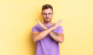 Genç, yakışıklı, İspanyol bir adam senin tavırlarından rahatsız ve bıkkın görünüyor. Yeter! Eller önde çapraz, durmanı söylüyor.