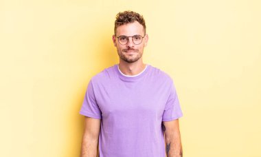 Genç, yakışıklı İspanyol adam pozitif ve kendinden emin gülümsüyor. Tatmin olmuş, arkadaş canlısı ve mutlu görünüyor.